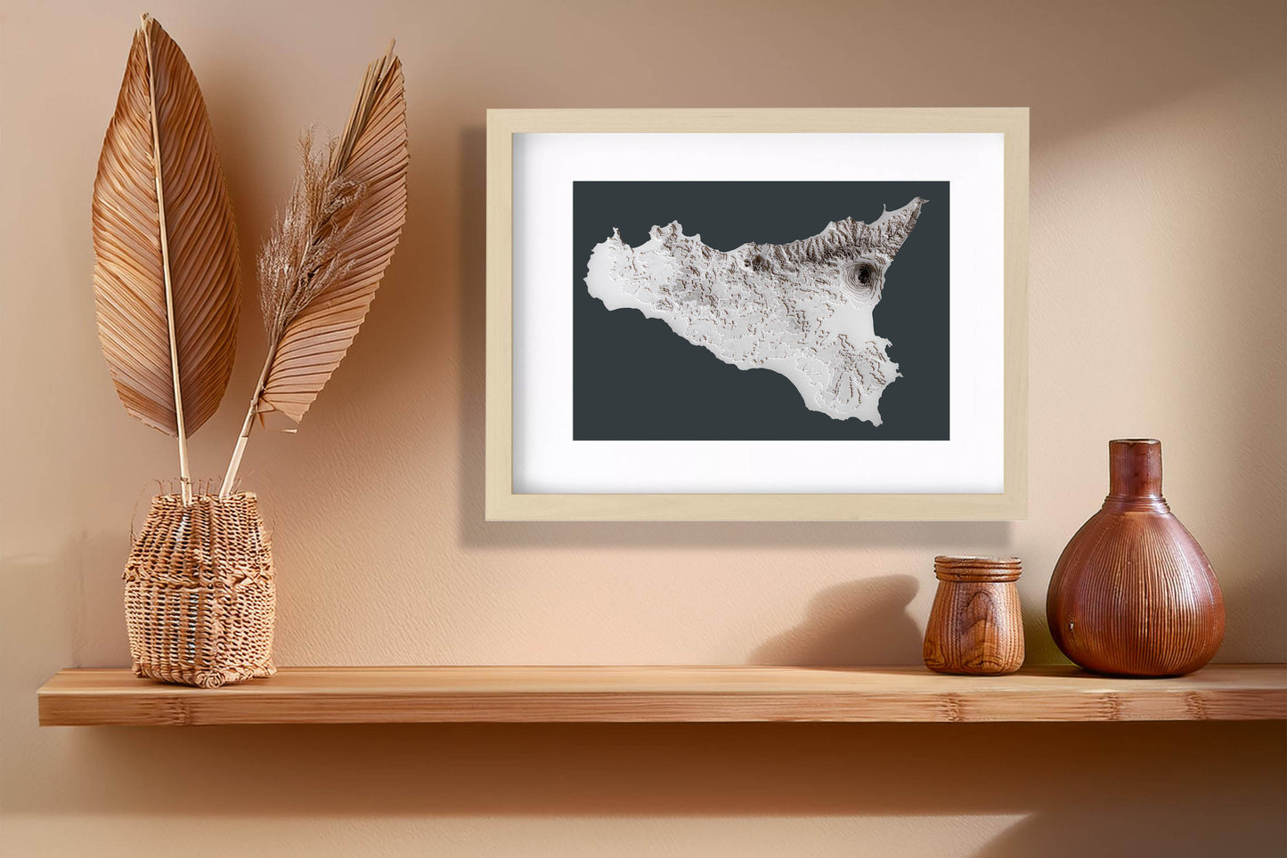 The 3D raised relief map of Sicily, crafted from layered cardstock, displayed elegantly on a desk. Thanks to its minimalistic design in a greyscale colour palette, the map will look great in most frame styles.