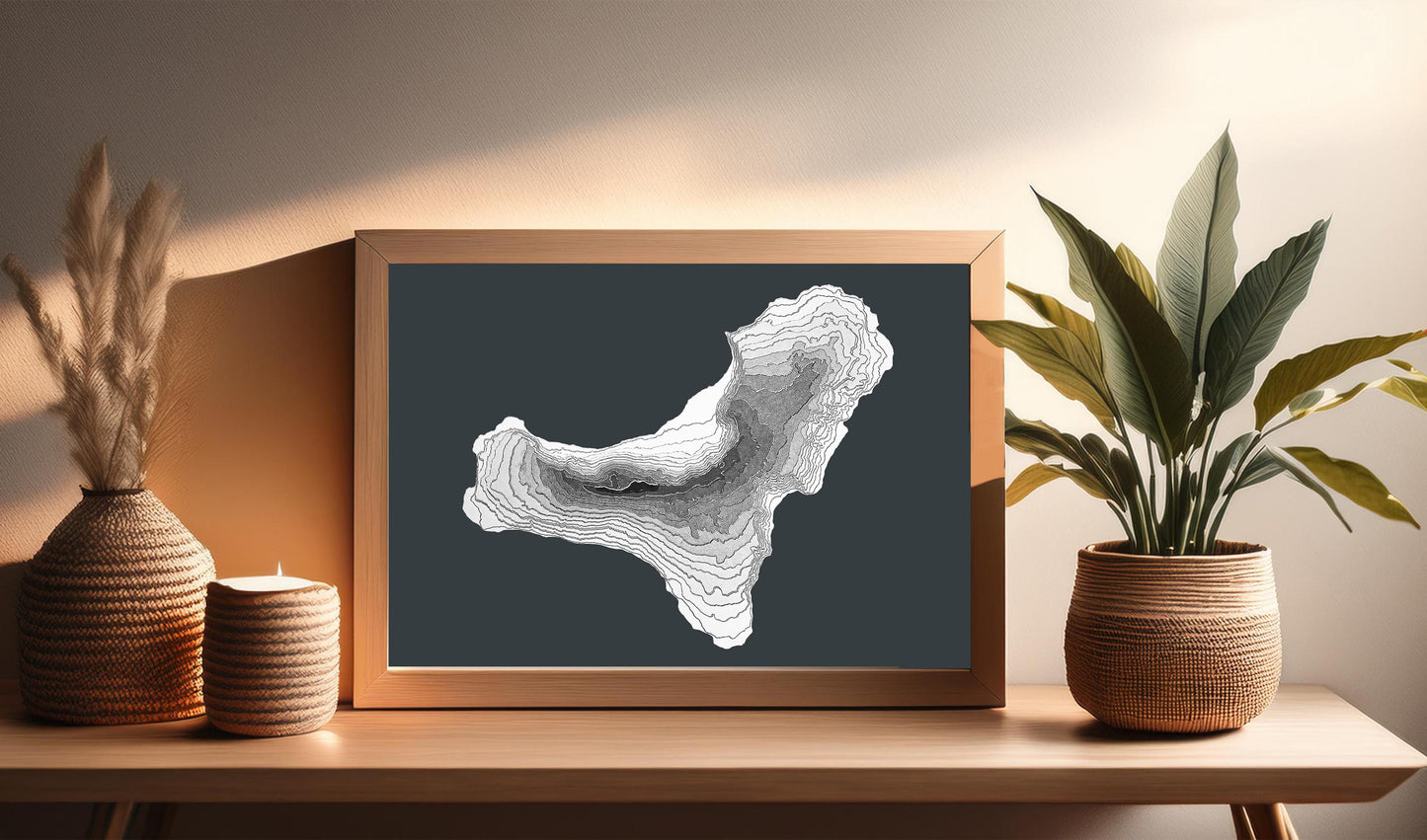 The 3D raised relief map of El Hierro island belonging to the Canary Islands archipelago is made of layered cardstock. In this image, the map is displayed in a wooden frame and resting on a table. It will look awesome in any kind of interior style.