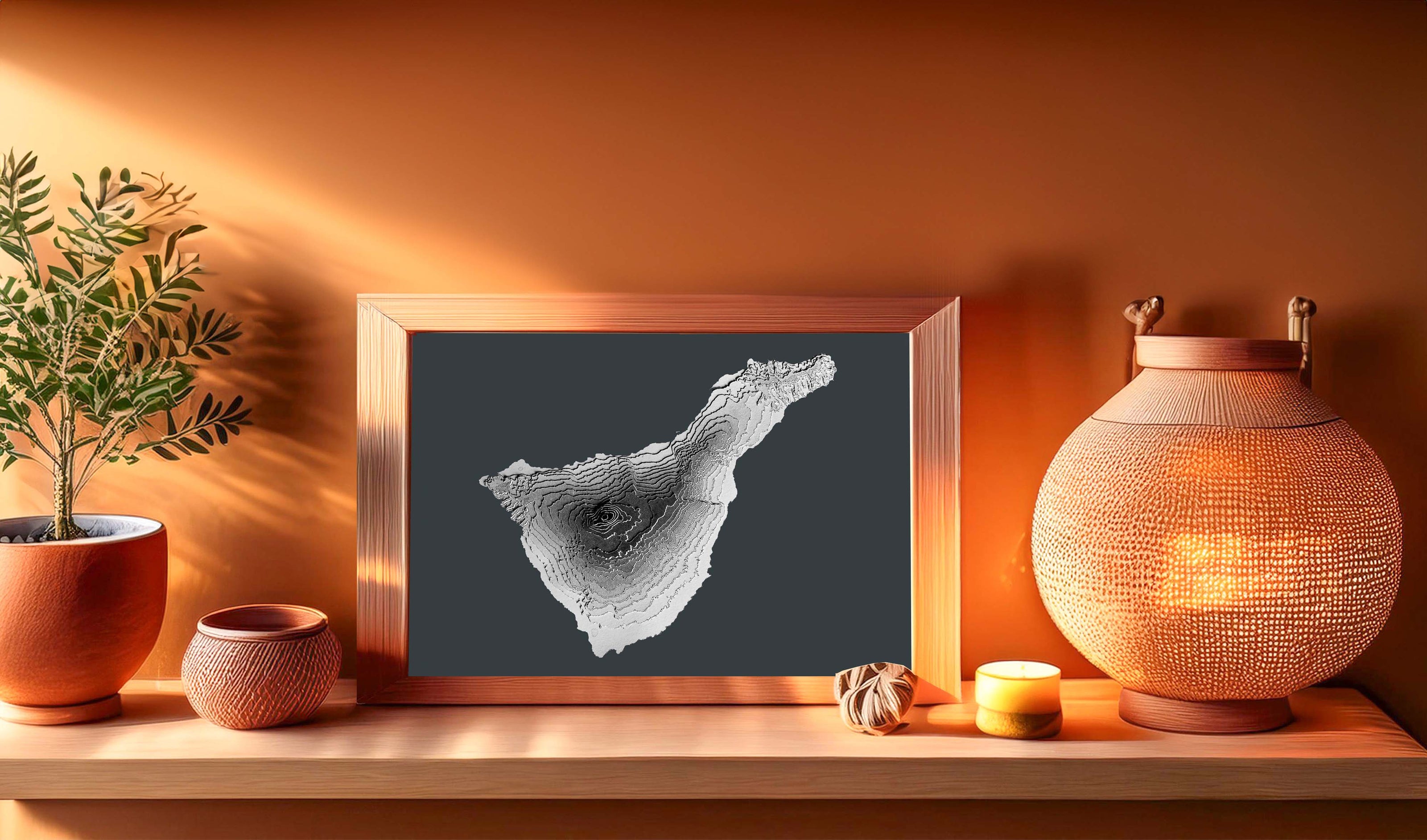 The 3 raised relief map of Tenerife is created in a greyscale colour palette and will therefore look good in most decoration settings. In this image it is in a wooden frame although the map is sold unframed. 